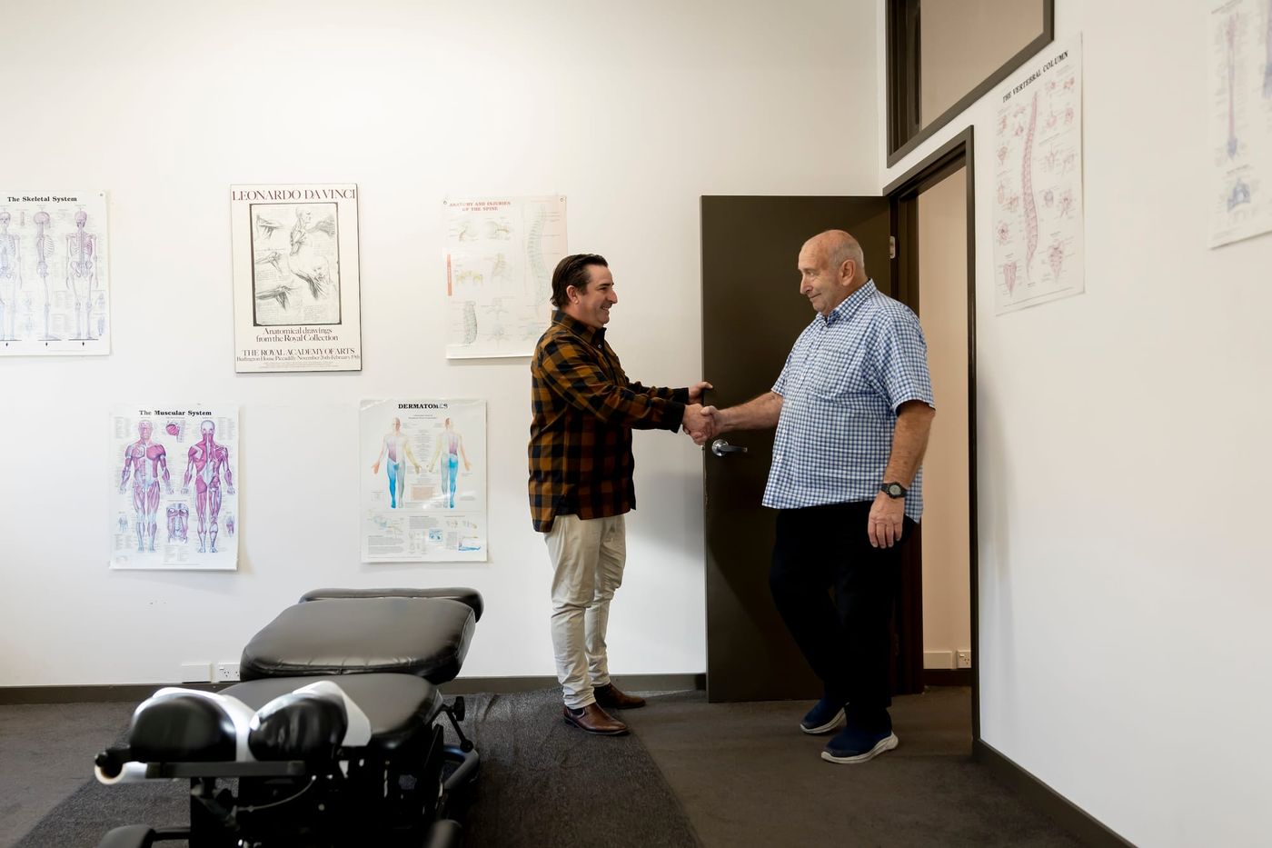 Simon shaking hands with a patient at the treatment room door