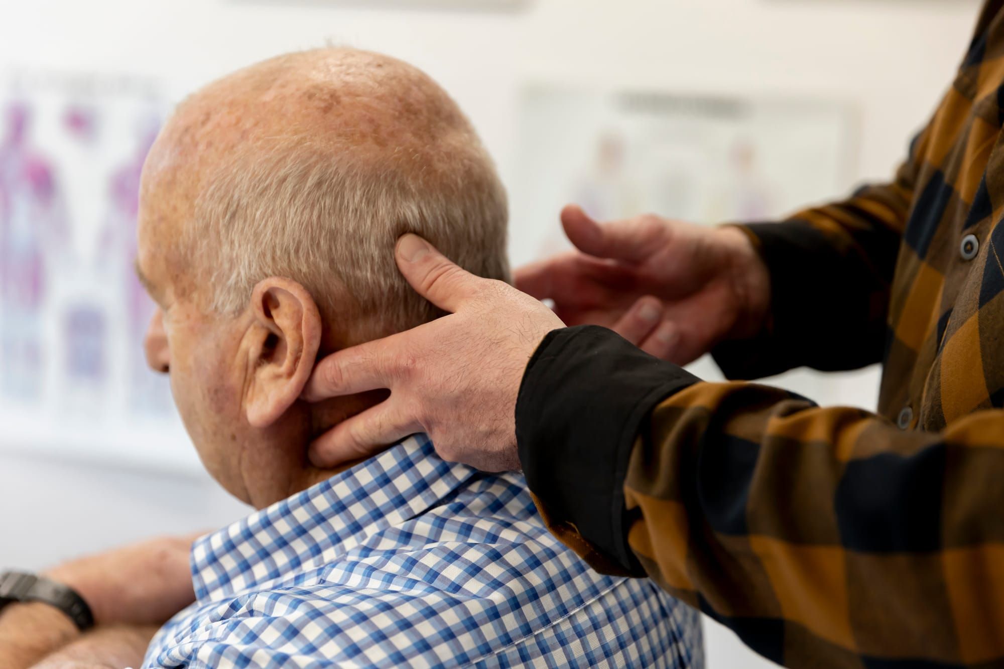 Simon's hands assessing a patient's neck